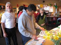 Visitors to gallery talking with Judy, admin assistant, and Mike Howard in white t-shirt on left