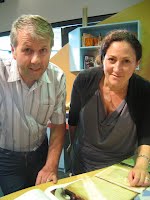 Tony Rasmussen, Te Manawa curator and Jackie Lequin looking at a precious   family handwritten French recipe book from 1906. 