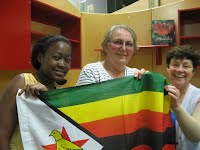 Dorcas and Joan, the Zimbabwean community with flag and Christine Coles,   Palmerston North facilitator