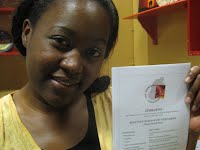 Dorcas Shumba holding her mother's favourite recipe (Dorcas rang her mother in Zimbabwe to check she remembered it correctly!)